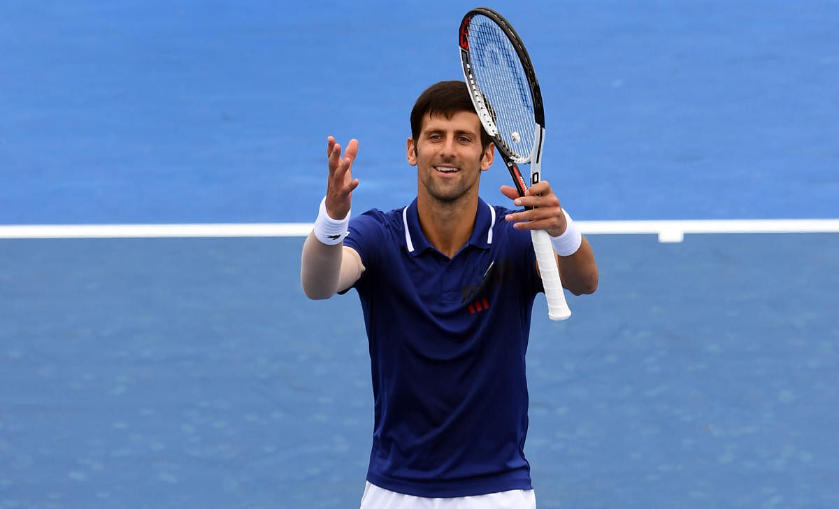 Novak Djokovic of Serbia waves to the crowds after winning his match against Dominic Thiem of Austria at Kooyong Classic tennis tournament in Melbourne on January 10, 2018. / AFP PHOTO / WILLIAM WEST / -- IMAGE RESTRICTED TO EDITORIAL USE - STRICTLY NO COMMERCIAL USE --