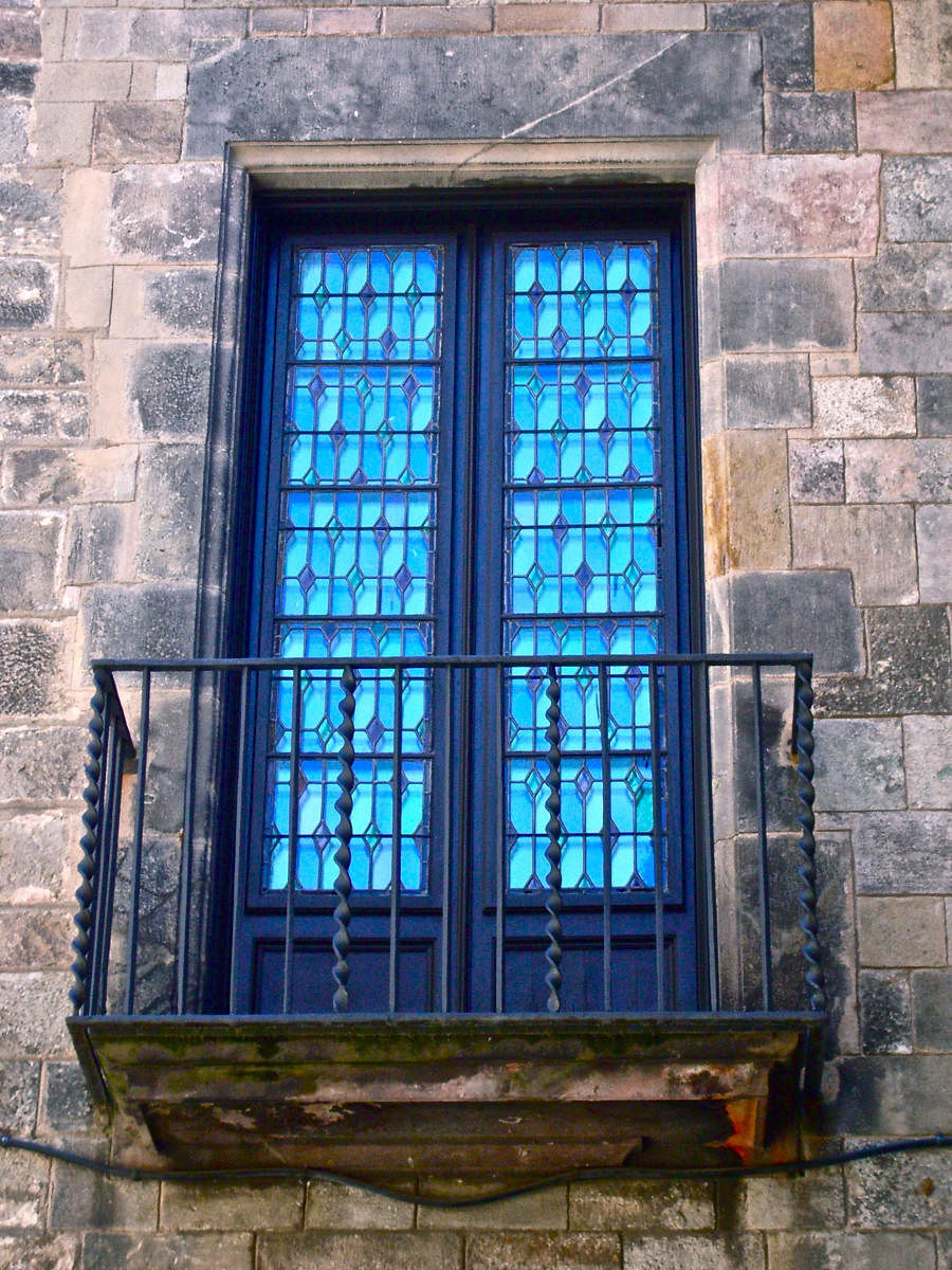 Blue glass window with Juliet balcony.