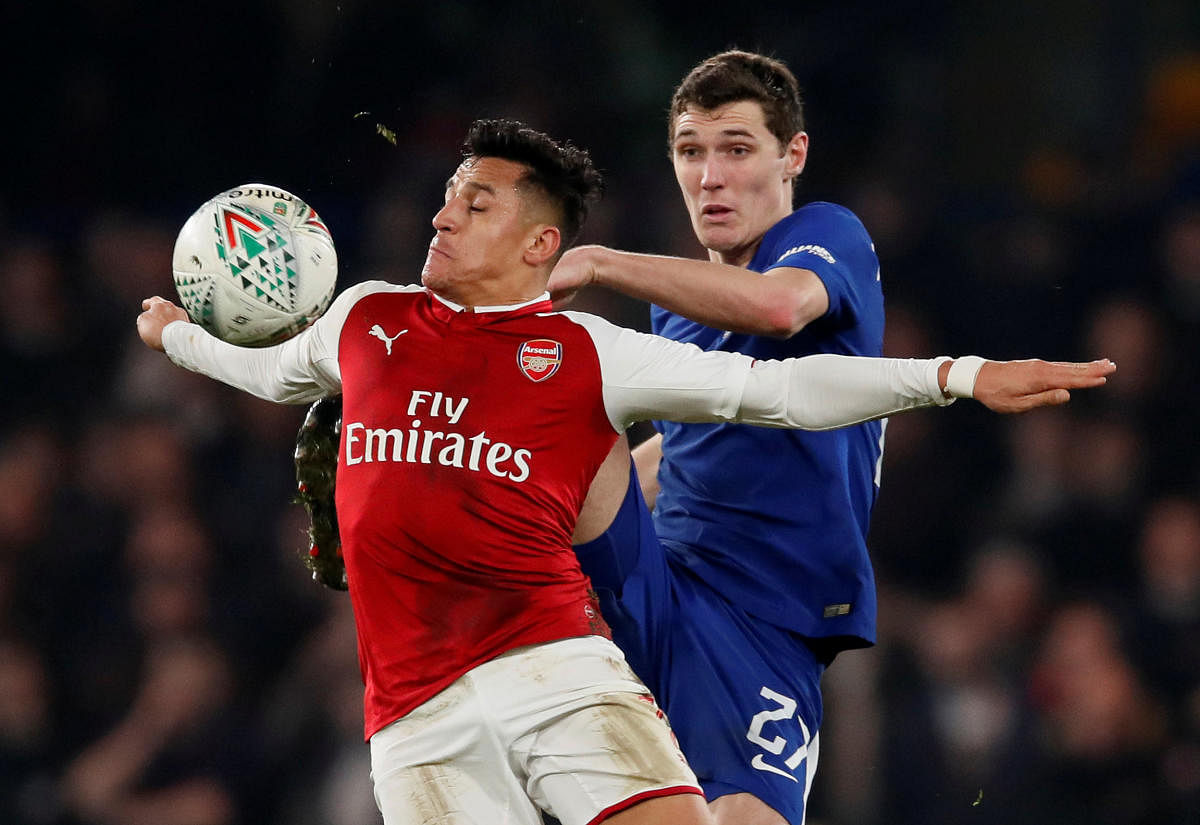 KEEN TUSSLE Arsenal's Alexis Sanchez in action with Chelsea's Andreas Christensen at Stamford Bridge on Wednesday. REUTERS