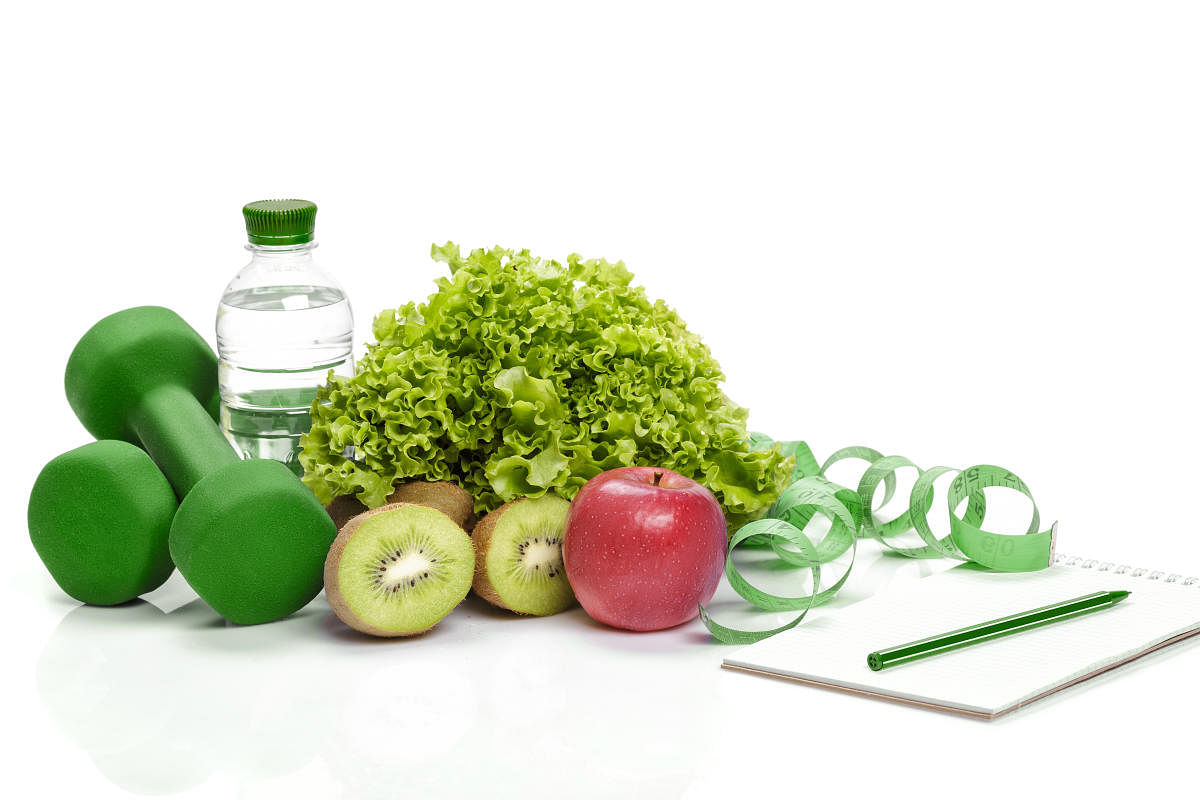healthy eating, diet and weight loss, detox . dumbbells, kiwi and a bottle of waterDiet