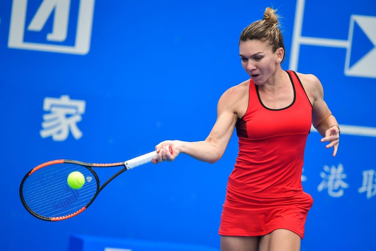 Simona Halep of Romania hit a return against Nicole Gibbs of the US in the first round of the Shenzhen Open tennis tournament in Shenzhen, in China's southern Guangdong province. Simona Halep goes in search of a first Grand Slam at the Australian Open next week without a sponsor, but happy she'll be able to wear her 'lucky' red dress. File photo.