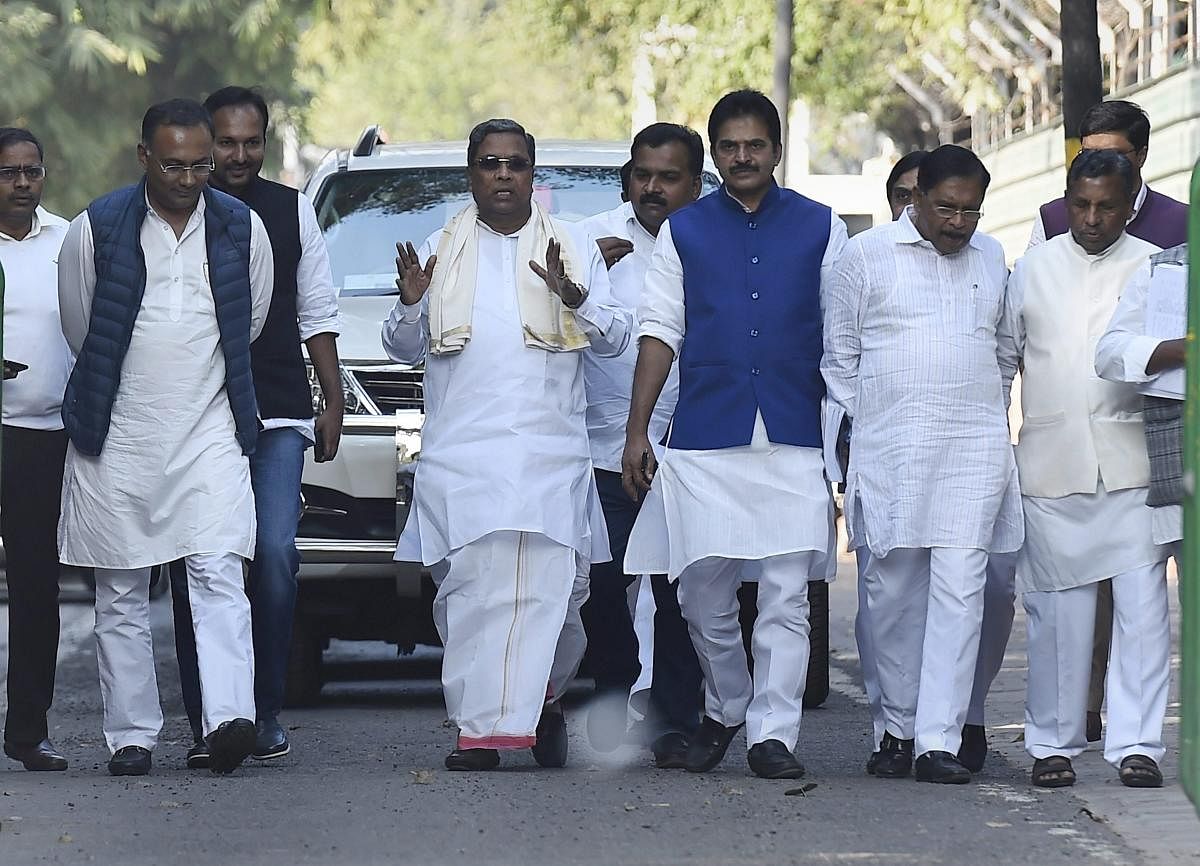Chief Minister Siddaramaiah, accompanied by Congress leaders (from left) Dinesh Gundu Rao, K C Venugopal, G Parameshwara and K H Muniyappa, leaves after meeting the AICC president Rahul Gandhi in New Delhi on Saturday. PTI Photo