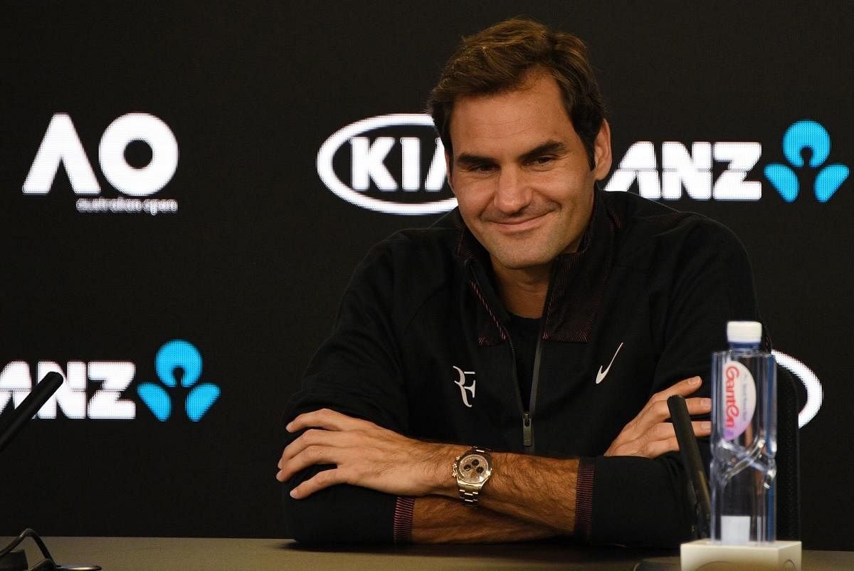 Switzerland's Roger Federer attends a press conference ahead of the Australian Open tennis tournament in Melbourne on January 14, 2018. / AFP PHOTO / SAEED KHAN / -- IMAGE RESTRICTED TO EDITORIAL USE - STRICTLY NO COMMERCIAL USE --