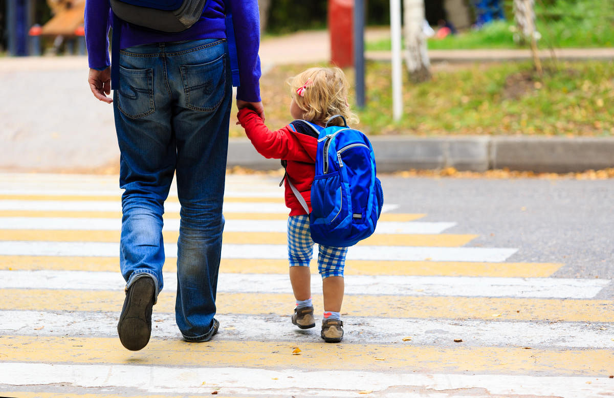 father walking little daughter with backpack to school or daycareFinancial planning