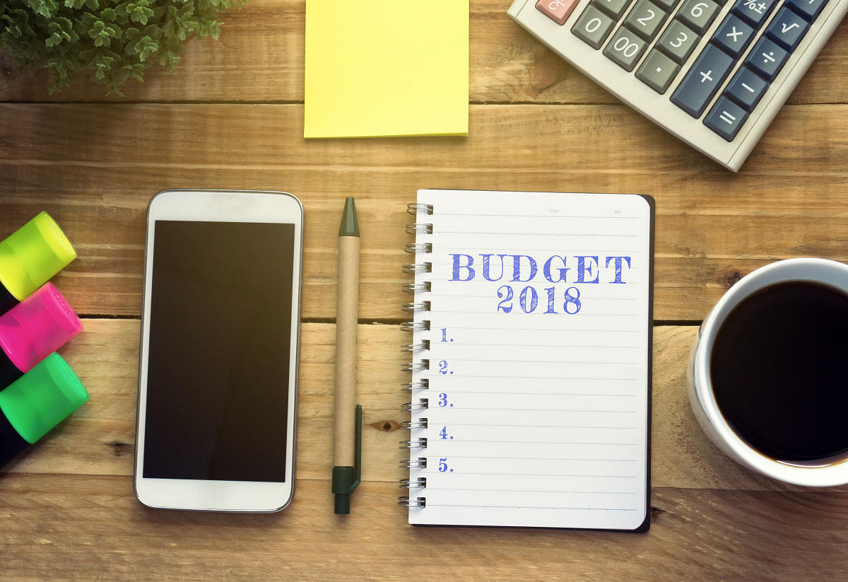 Financial and new year concept - Budget 2018 list written on a notepad with flat lay office desk and office supplies background.Budget 2018