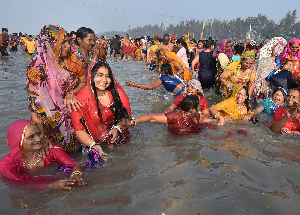 Devotees taking holy dip at Gangasagar (Sagar Island) on the occasion of 'Makar Sankranti' on Sunday. PTI Photo