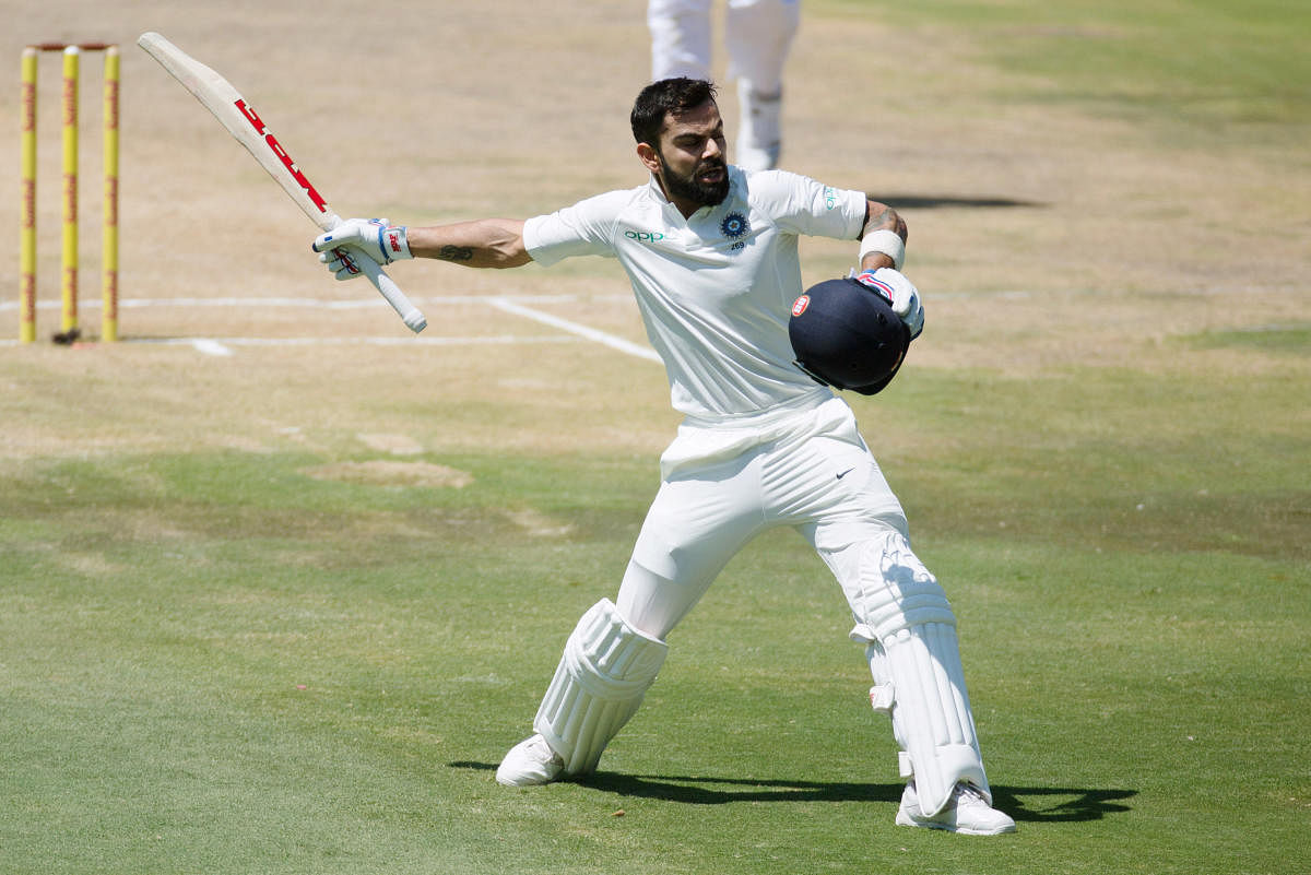 Standing tall: India's Virat Kohli celebrates his century against South Africa on the third day of the second Test. REUTERS