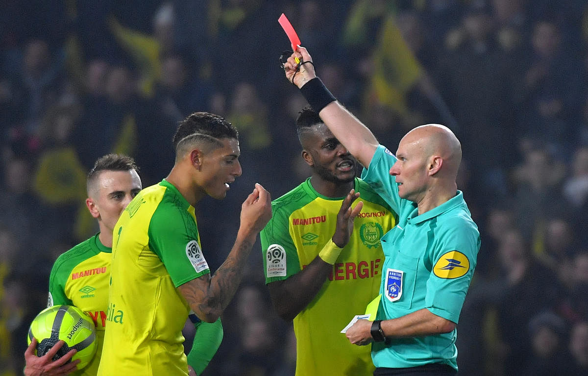 Bizarre: Referee Tony Chapron showing Nantes' defender Diego Carlos a red card during their game against Paris St Germain in Ligue 1 on Sunday. AFP