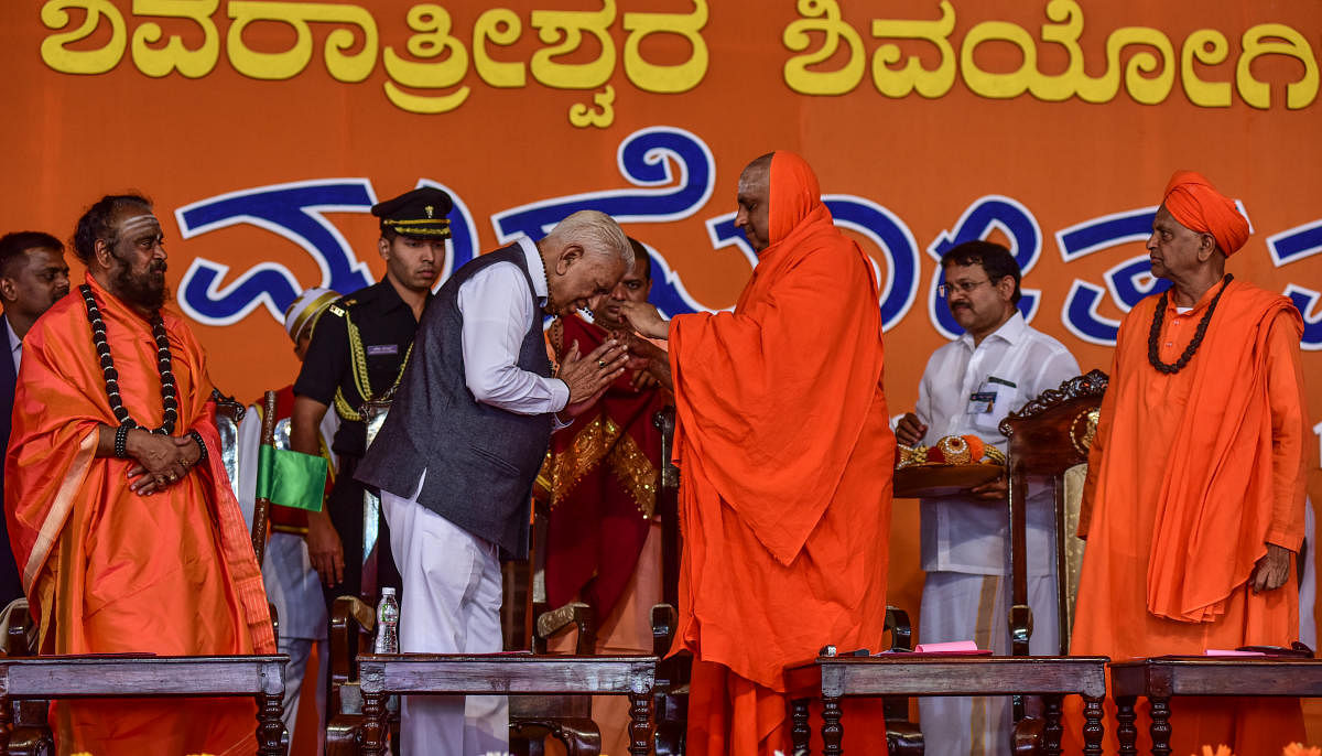 Governor Vajubhai Rudabhai Vala being felicitated during a programme in Suttur, Nanjangud taluk, on Monday. Rambhapuri seer Prasanna Veerasomeshwara Shivacharya Swami, Suttur seer Shivarathri Deshikendra Swami, and Duradundeshwara Nidasodi seer Panchama Shivalingeshwara Swami are seen.
