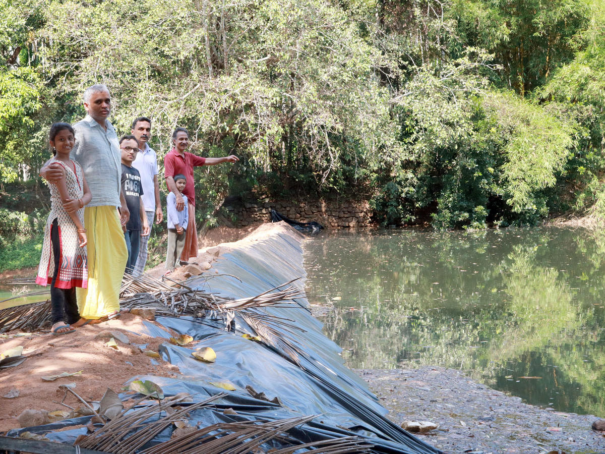 Farmers showing the temporary check dam constructed by them.