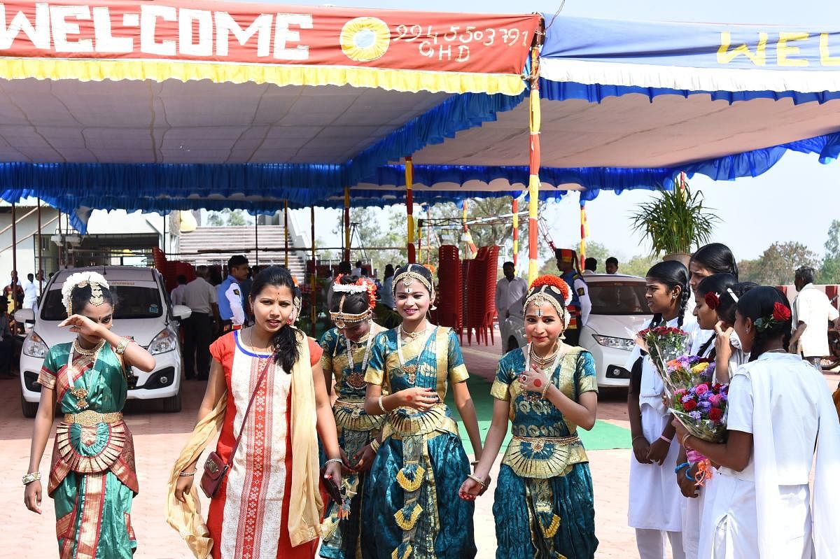 Students, who came in Bharatanatya dress to perform welcome song, return from the meditation pyramid inauguration venue near Nrupatunga Betta in Hubballi on Tuesday, after the function was cancelled.