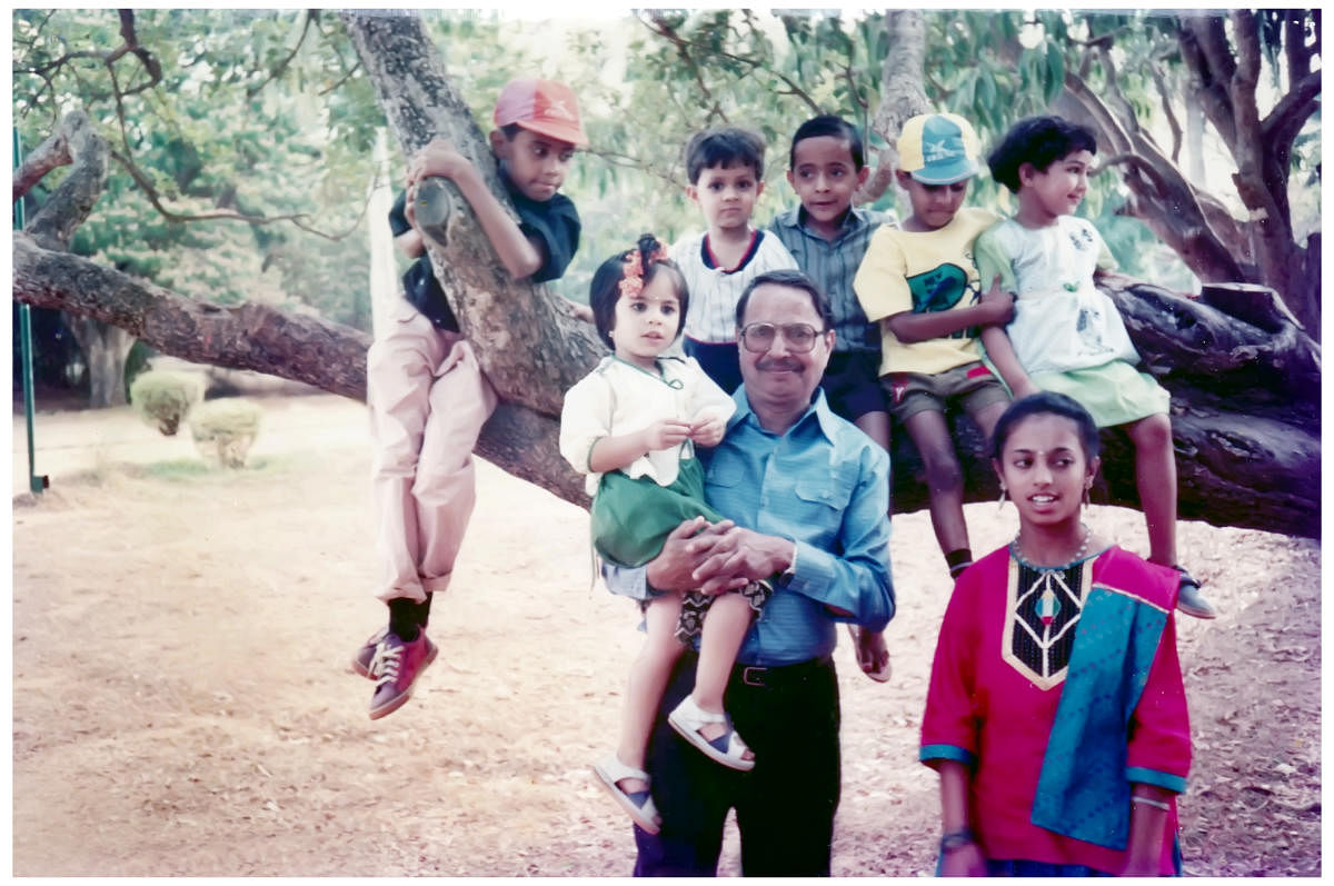 (From left, sitting on the branch) Srikrishna, Neil, Naresh, Vivek, the author. (Standing) Shivashankar, Sandhya (in arms) and Meera.