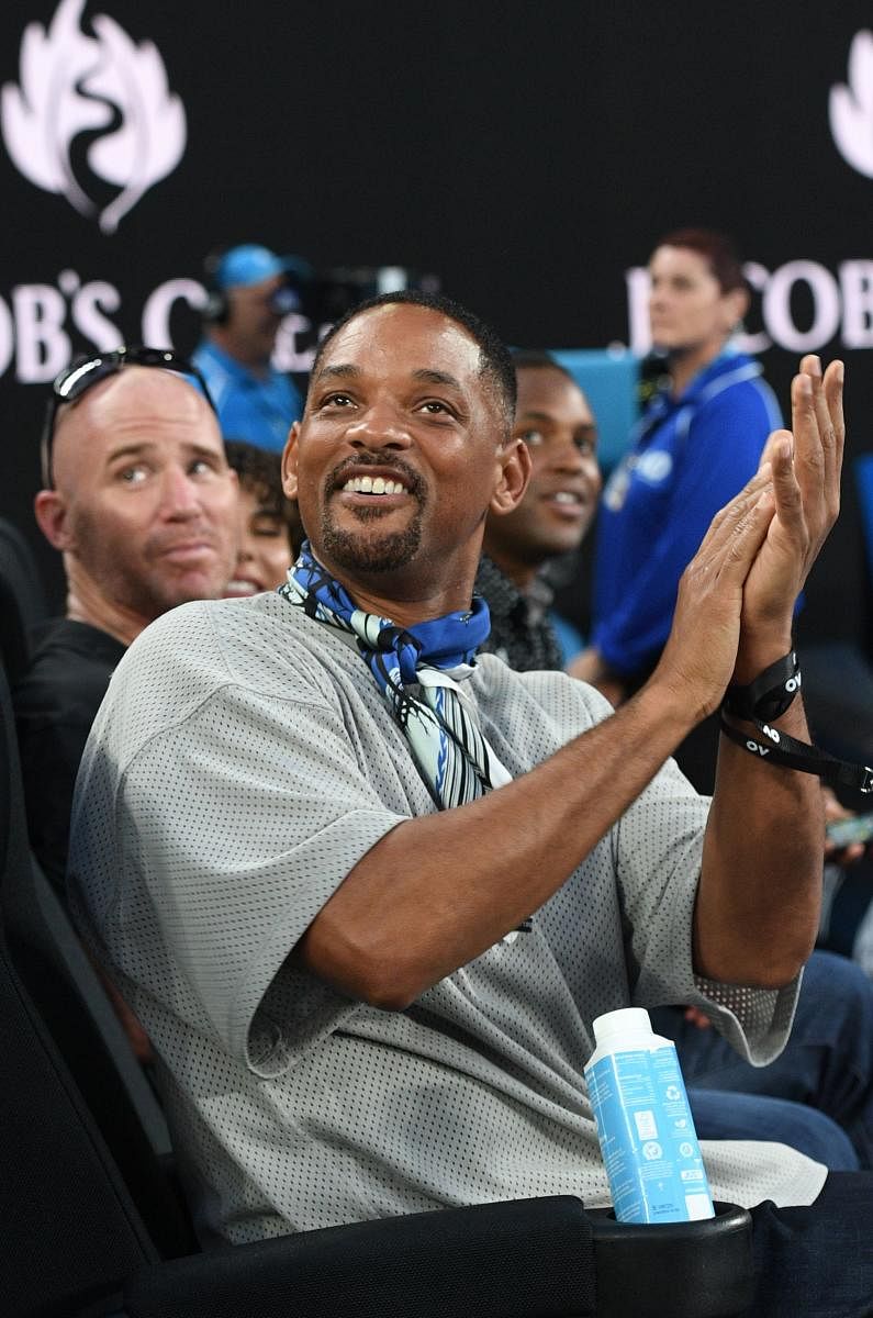 STAR STUDDED: Actor Will Smith applauds spectators during the men's singles third round match between Australia's Nick Kyrgios and France's Jo-Wilfried Tsonga on Friday. AFP