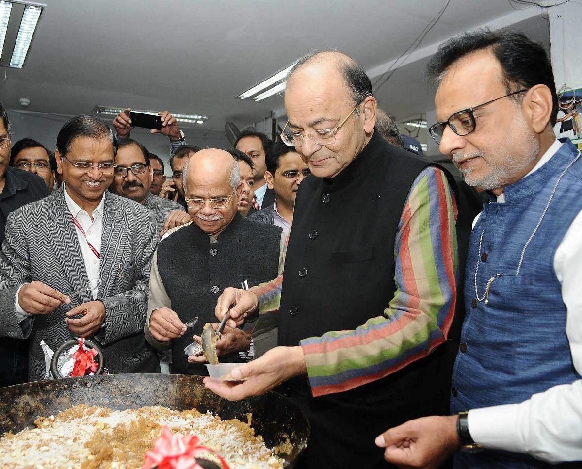 Union Minister for Finance and Corporate Affairs, Arun Jaitley at the halwa ceremony to mark the commencement of budget printing process for Union Budget 2018-19, in New Delhi on Saturday. MoS for Finance, Shiv Pratap Shukla and the Finance Secretary, Hasmukh Adhia are also seen. PTI Photo/ PIB (PTI1_20_2018_000088B)