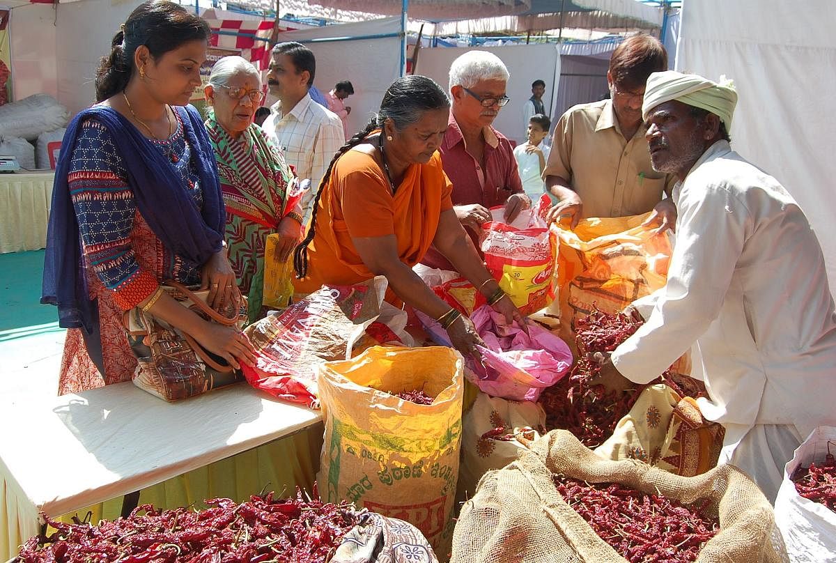 Visitors purchase red chilli at the Chilli Mela which began at Moorusaviramutt High School ground in Hubballi on Saturday.