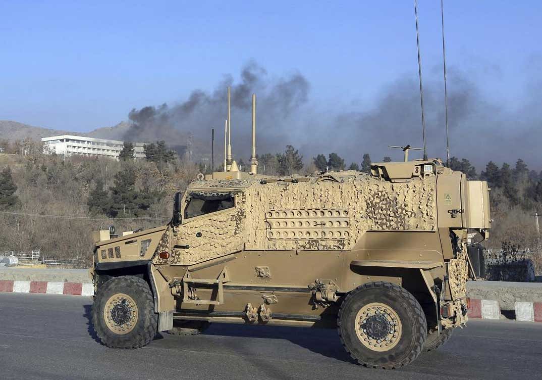 U.S. forces' vehicle arrives as smoke rises from the Intercontinental Hotel after an attack in Kabul, Afghanistan. AP, PTI Photo