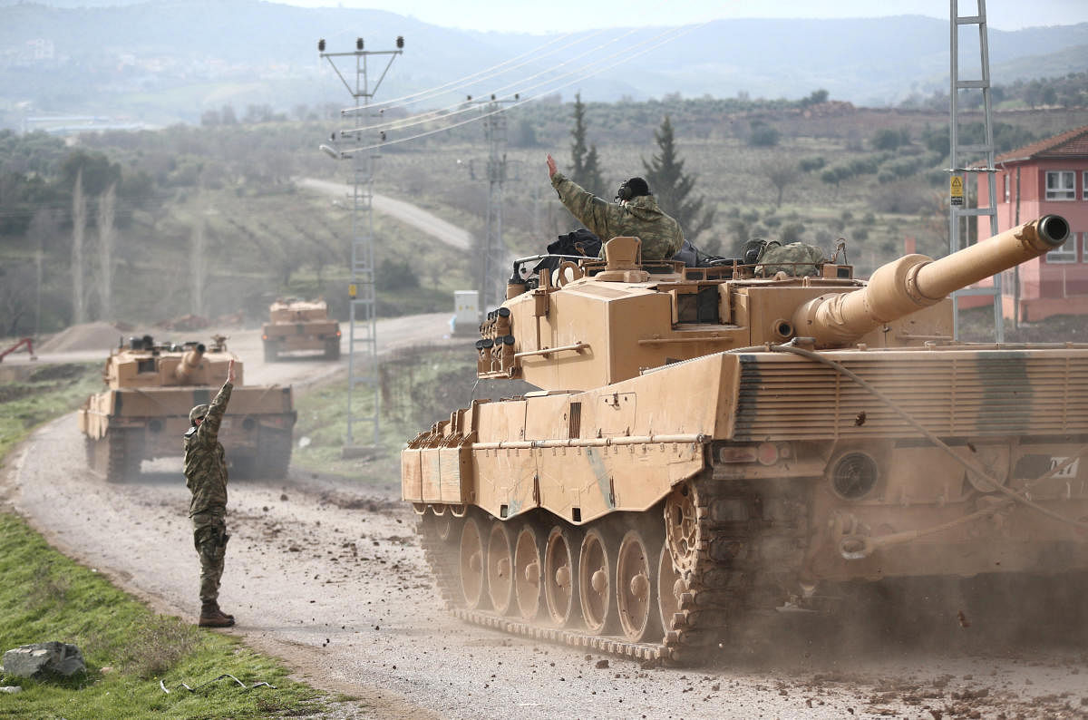A Turkish military convoy arrives at a village on the Turkish-Syrian border in Kilis province, Turkey, on Sunday. REUTERS