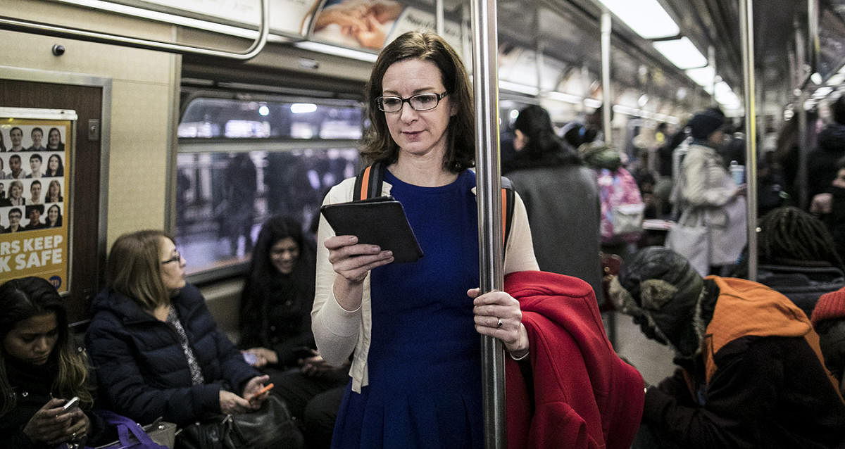 Alexandra Alter, who covers the book publishing industry for The New York Times, reads a Kindle while riding the subway in Manhattan, Jan. 11, 2018. Alter says she's on her fifth Kindle.