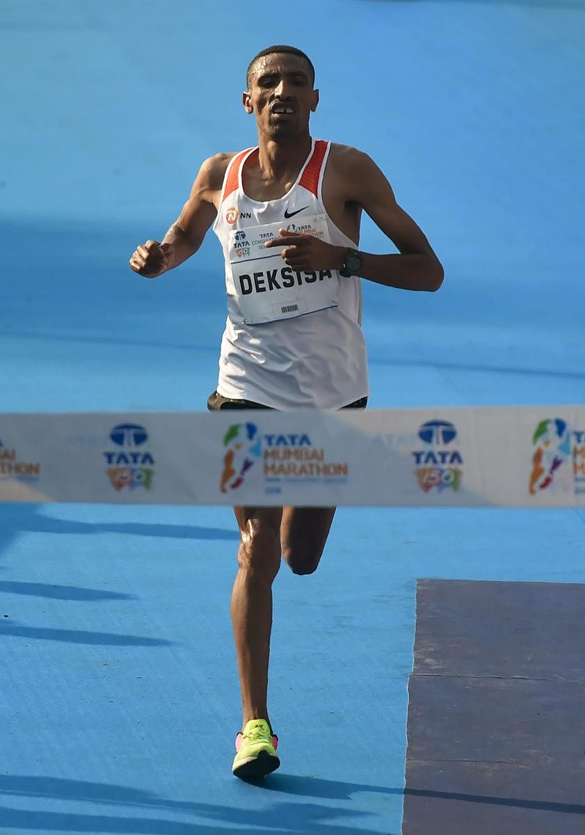 TRIUMPHANT: Ethiopia's Solomon Deksisa (left) and Amane Gobena won the men's and women's crowns respectively at the Mumbai Marathon on Sunday. PTI