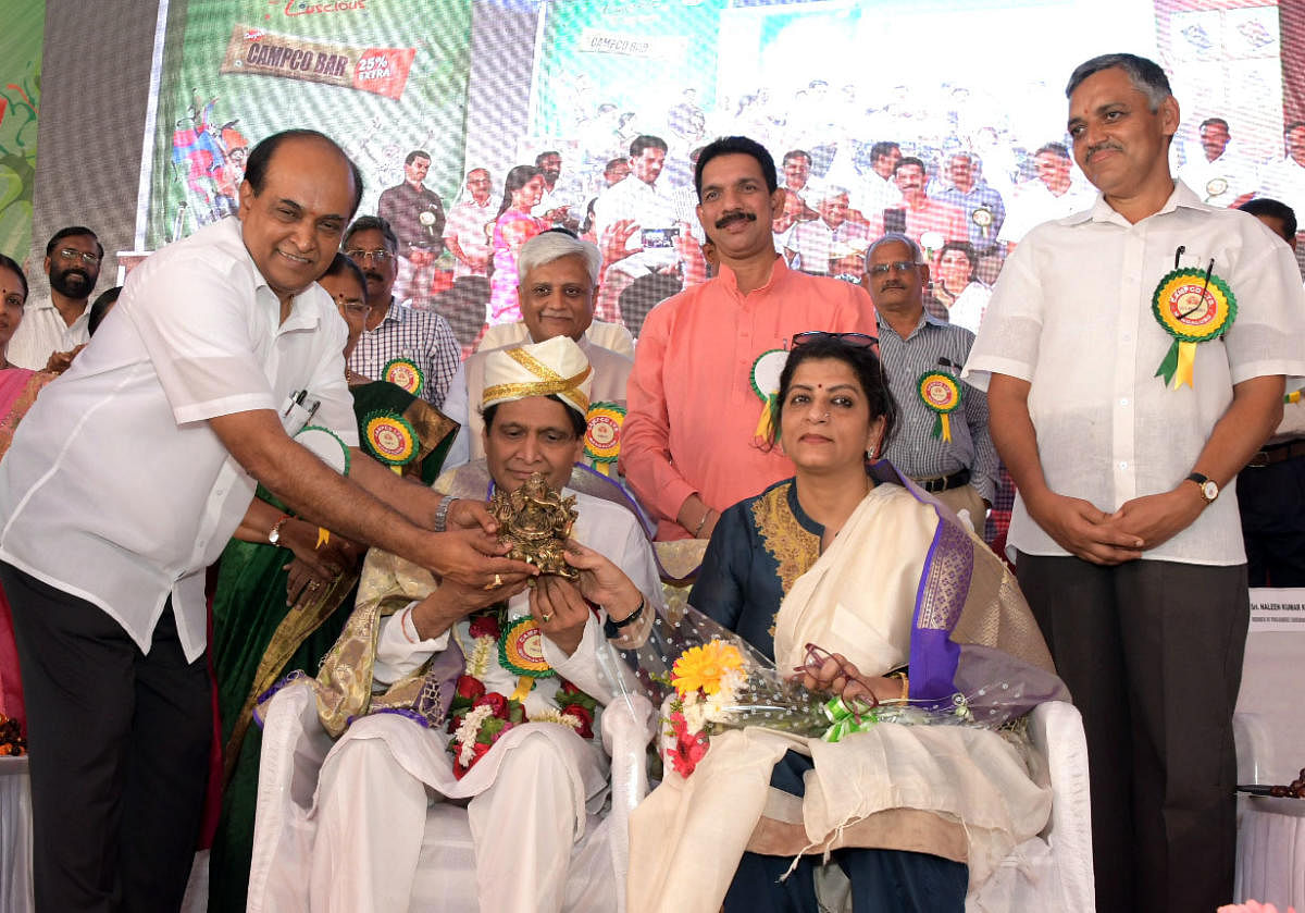 Union Commerce and Industries Minister Suresh Prabhu and his spouse Uma Prabhu being felicitated during the inaugural ceremony of the new amenity building at Campco chocolate factory premises in Puttur on Sunday. DH Photo