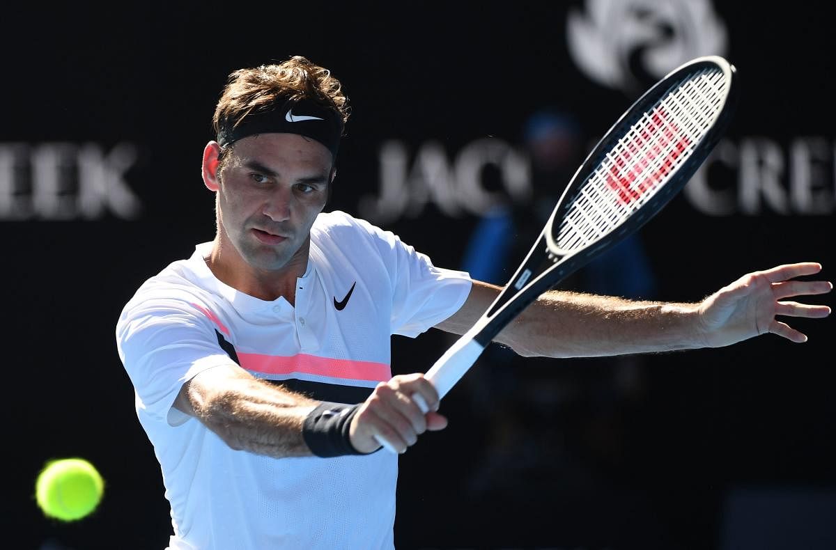 Switzerland's Roger Federer hits a return against Marton Fucsovics of Hungary during their men's singles fourth round match at the Australian Open on Monday.