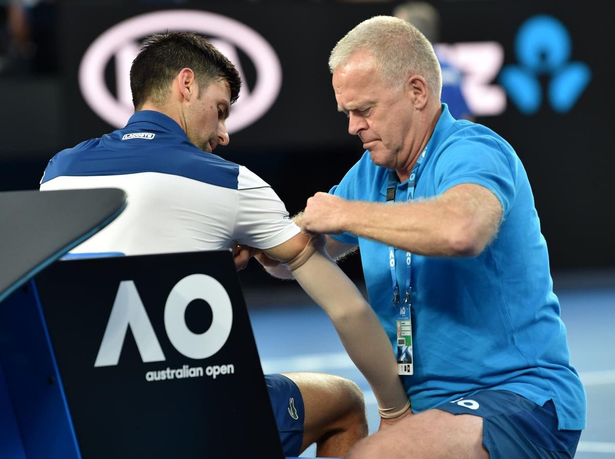 Serbia's Novak Djokovic receives medical attention after the opening set during his fourth round clash against South Korea's Hyeon Chung. AFP