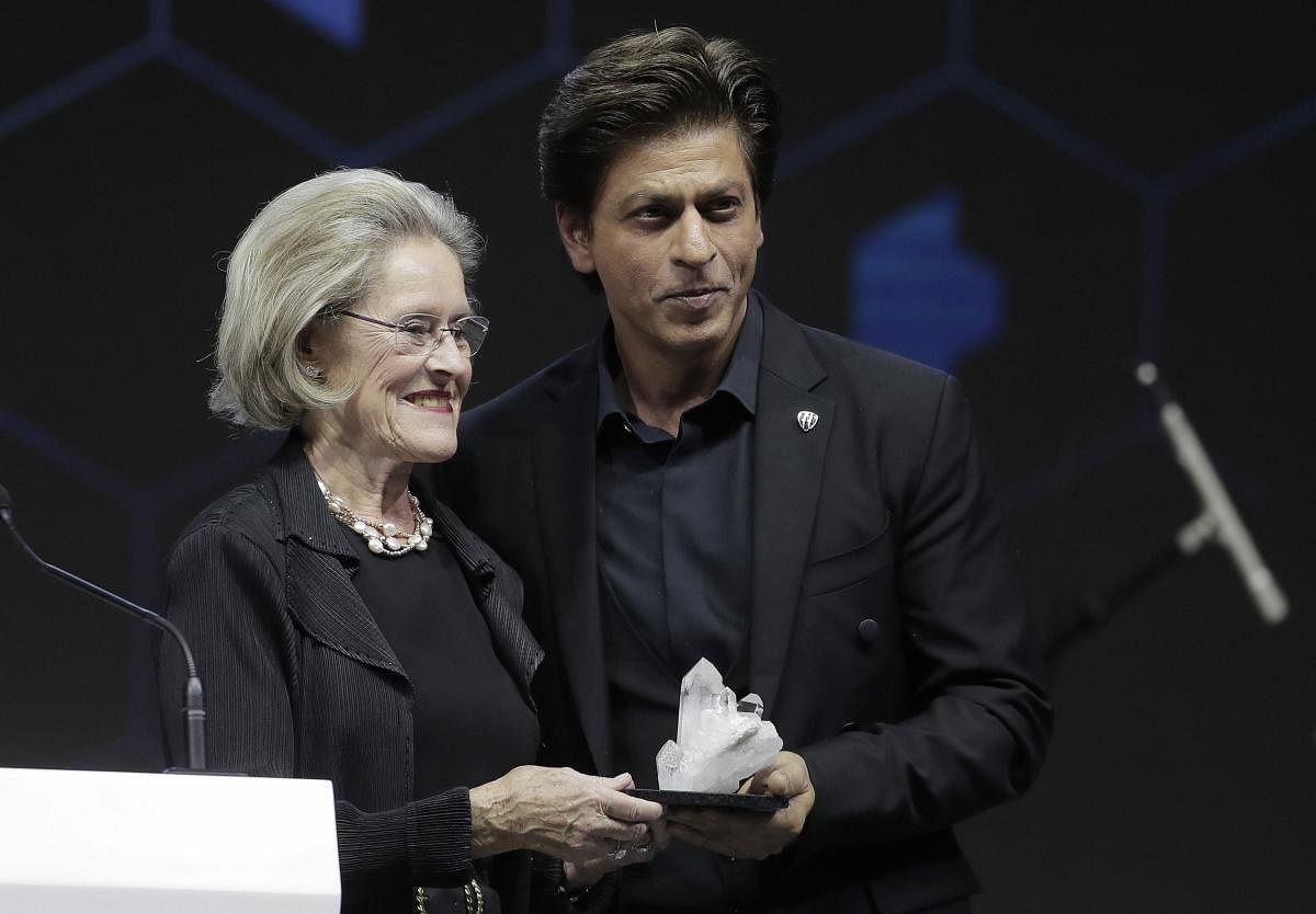 Indian actor Shah Rukh Khan, right, receives a Crystal Award by Hilde Schwab, Chairwoman and Co-Founder of the World Economic Forum's World Arts Forum, during a ceremony on the eve of the annual meeting of the World Economic Forum in Davos, Switzerland. AP/PTI Photo