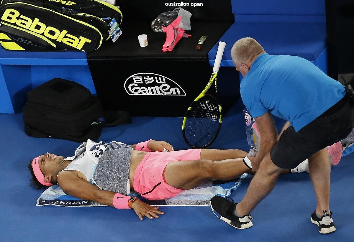 Rafael Nadal receives medical assistance during his match against Marin Cilic of Croatia.