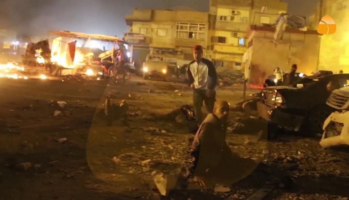 This grab taken from Al-Hadath Channel video on Tuesday Jan. 23, 2018, shows debris at the site of an explosion in Benghazi, Libya. Two consecutive car bombs detonated near a mosque in the Libyan city of Benghazi on Tuesday, killing at least nine people and injuring dozens more.