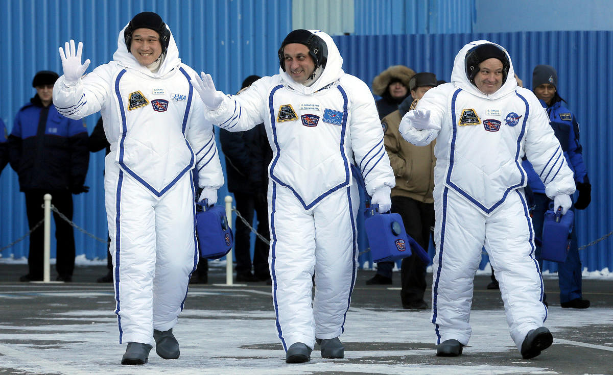 Members of the International Space Station expedition 54/55, Roscosmos cosmonaut Anton Shkaplerov (C), NASA astronaut Scott Tingle (R) and Norishige Kanai (L) of the Japan Aerospace Exploration Agency (JAXA) during the send-off ceremony after checking their space suits before the launch of the Soyuz MS-07 spacecraft at the Baikonur cosmodrome, in Kazakhstan, 17 December 2017.