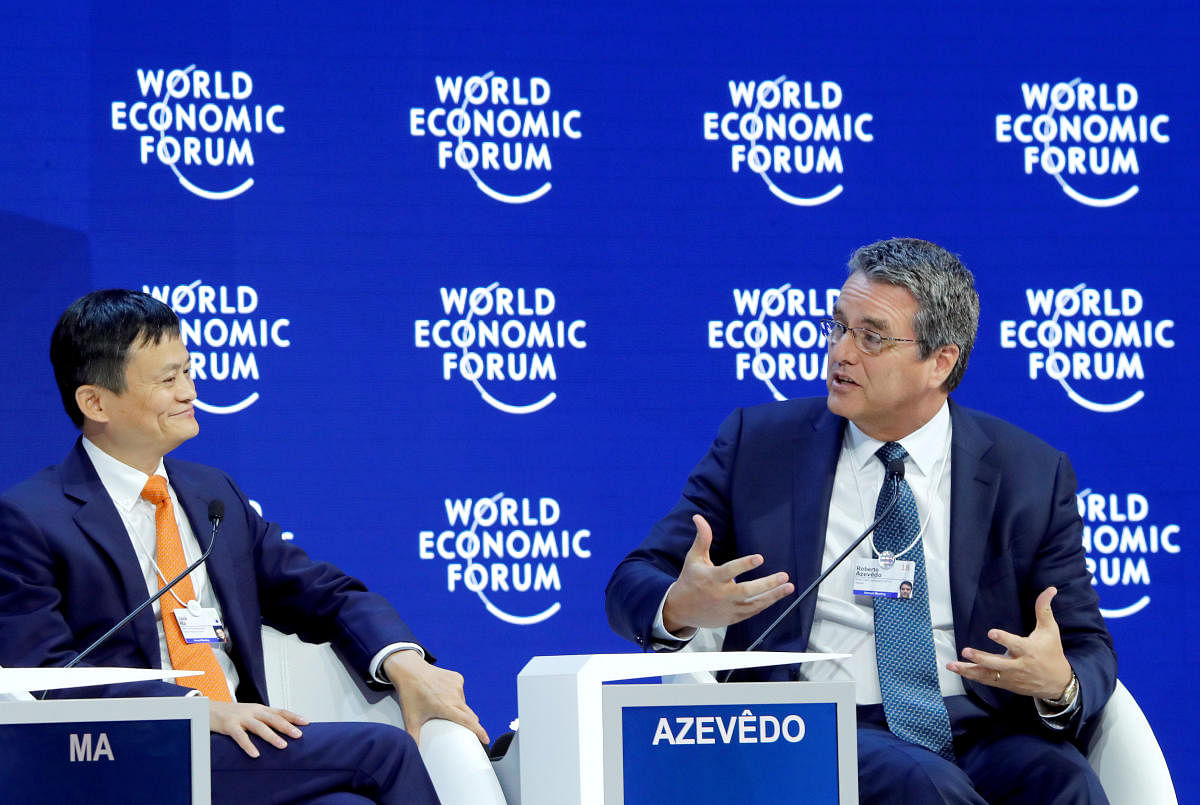 Roberto Azevedo, Director-General of the World Trade Organization (WTO), speaks to Jack Ma, Executive Chairman of Alibaba Group Holding, during the World Economic Forum (WEF) annual meeting in Davos, Switzerland January 24, 2018.
