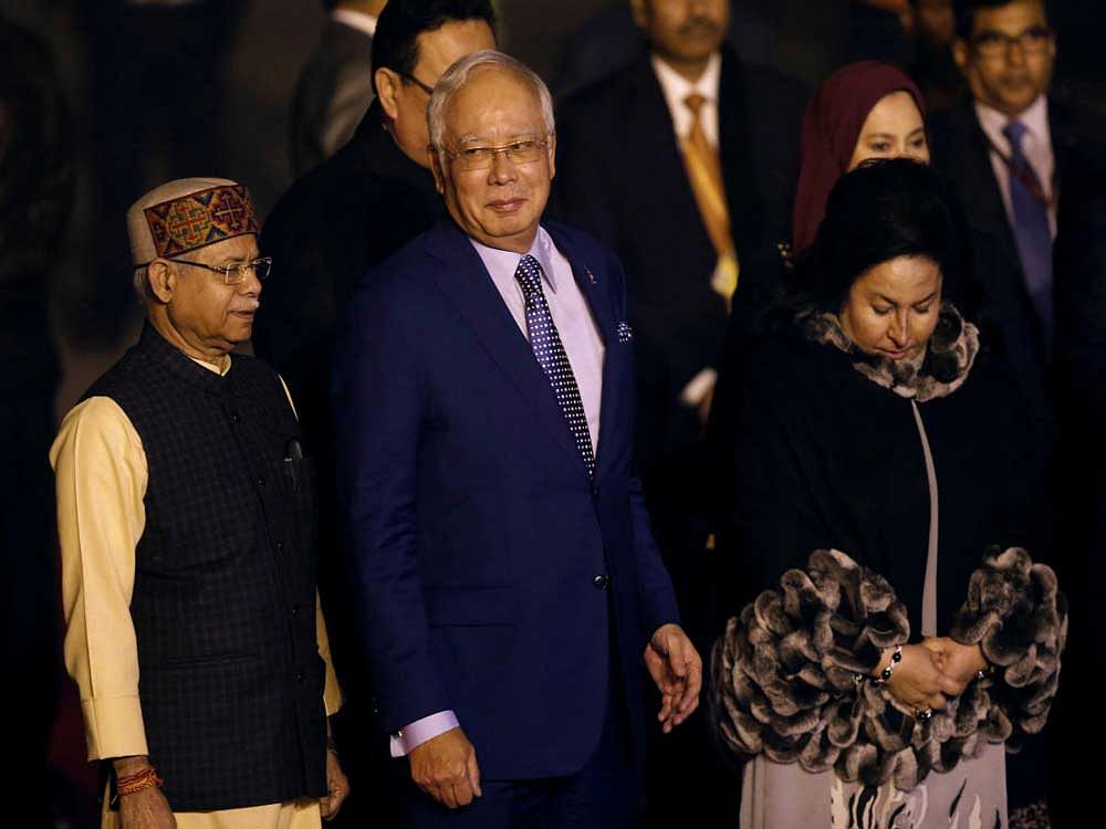 Malaysia's Prime Minister Najib Razak and his wife Rosmah Mansor walk towards their car after arriving at Air Force Station Palam in New Delhi. Reuters Photo