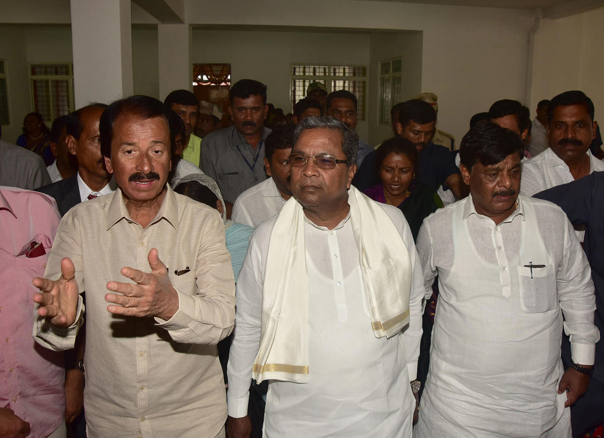 MLA Vasu explains to Chief Minister Siddaramaiah about the facilities at newly constructed Maharani's Commerce and Management College for Women, at Paduvarahalli in Mysuru on Wednesday. PWD Minister Dr H C Mahadevappa is seen.