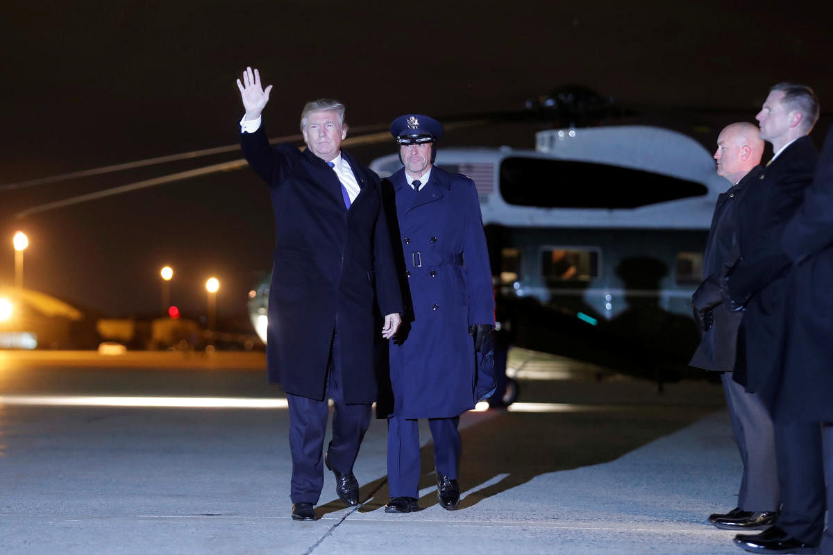 U.S. President Donald Trump waves as he boards Air Force One for travel to Switzerland to attend the World Economic Forum (WEF) annual meeting in Davos from Joint Base Andrews, Maryland, U.S., January 24, 2017. REUTERS