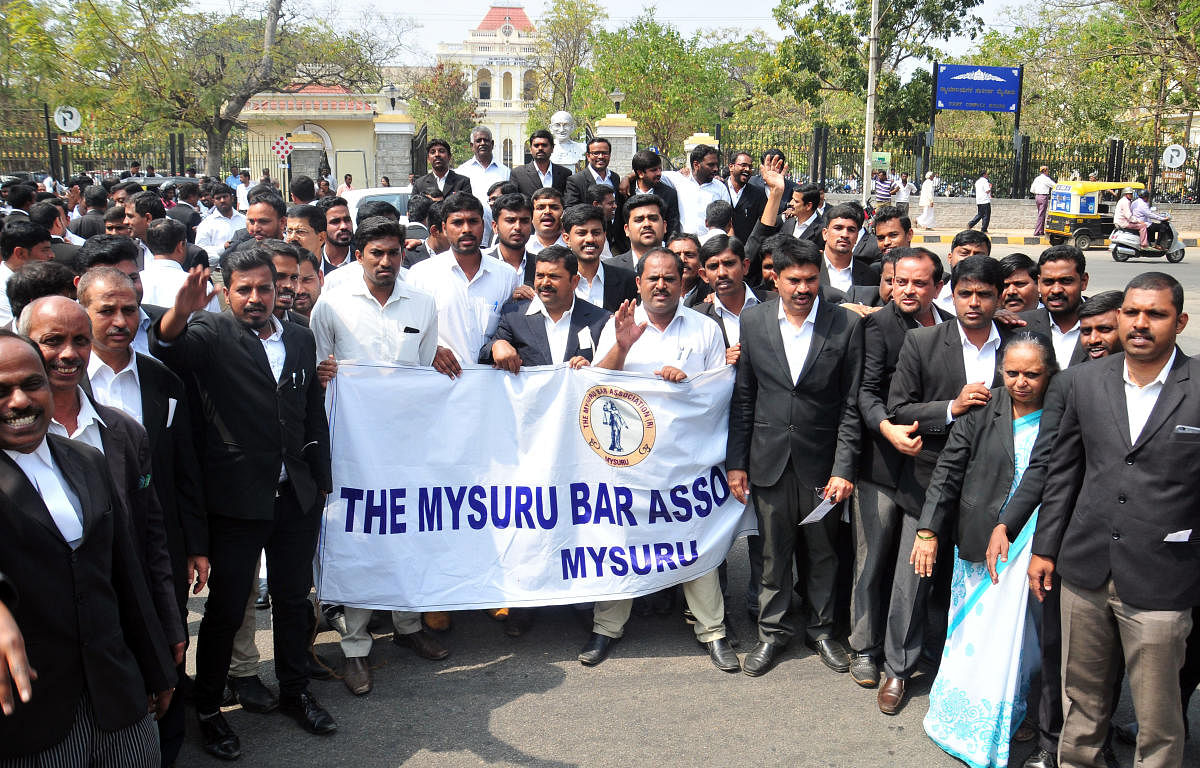 Members of the Bar Association stage a protest near the Mahatma Gandhi's bust, near the Court Complex in Mysuru on Thursday.