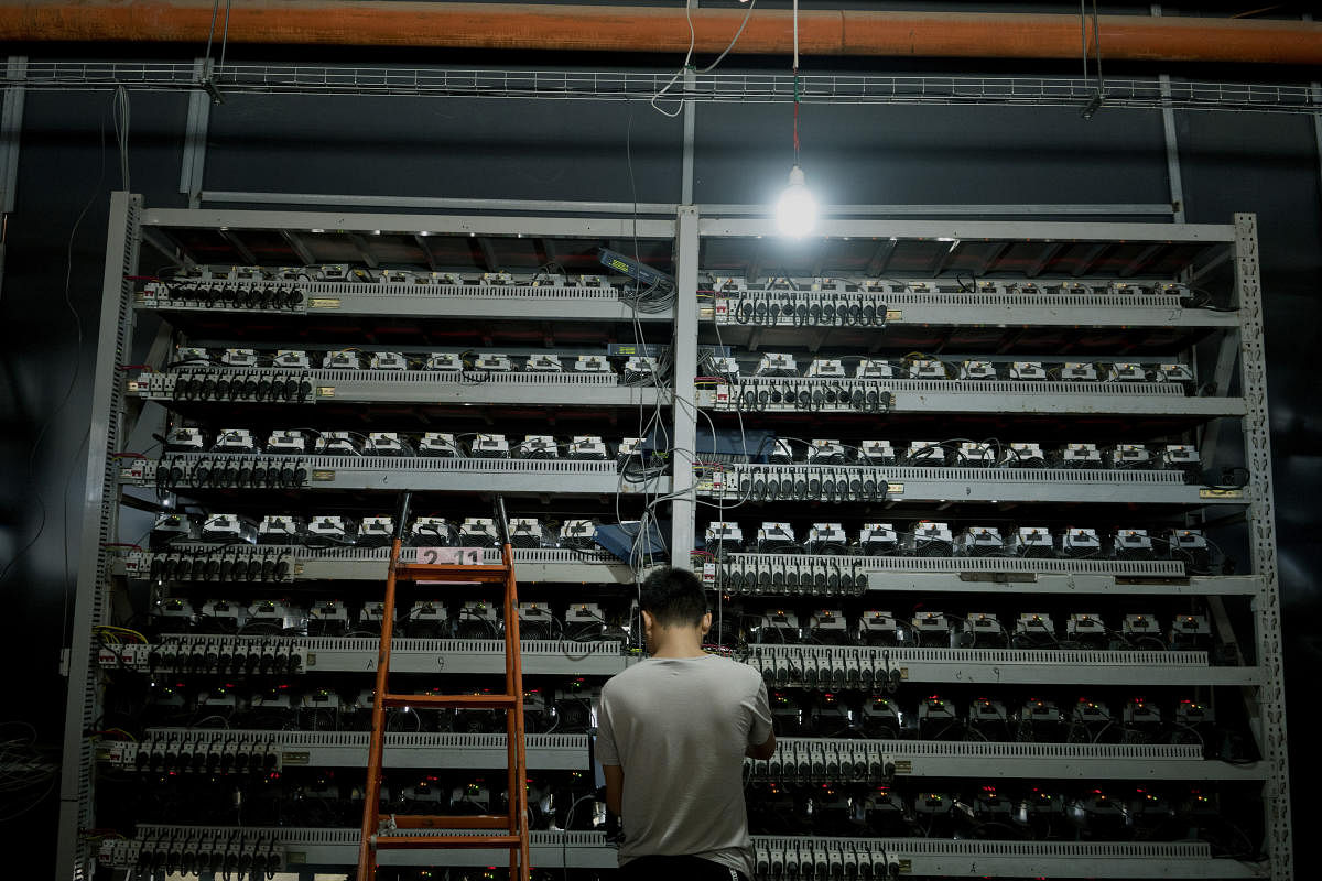 Li Shuangsheng, works at Bitmain, a Bitcoin farm in Dalad Banner, Mongolia, Aug. 11, 2017. Creating a single cryptocurrency token requires as much electricity as two years worth of consumption by an average American home. (Giulia Marchi for The New York Times)