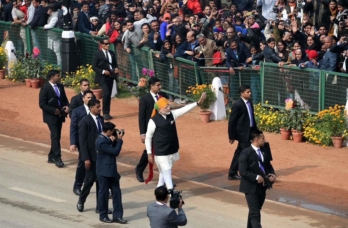 Indian Prime Minister Narendra Modi (C) waves to spectators and the end of India's 69th Republic Day Parade in New Delhi