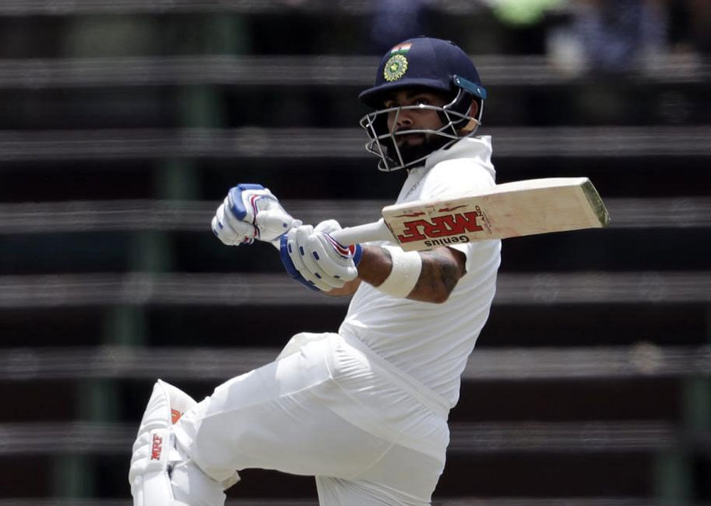 Virat Kohli watches his shot on the third day of the third cricket Test match between South Africa and India at the Wanderers Stadium in Johannesburg. AP/PTI photo.