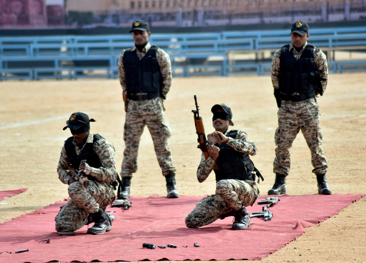 Blind-folded personnel of the newly launched Commando Force assembles weapons, during the 69th Republic Day Celebration at the Torch Light Parade Grounds in Mysuru on Friday.