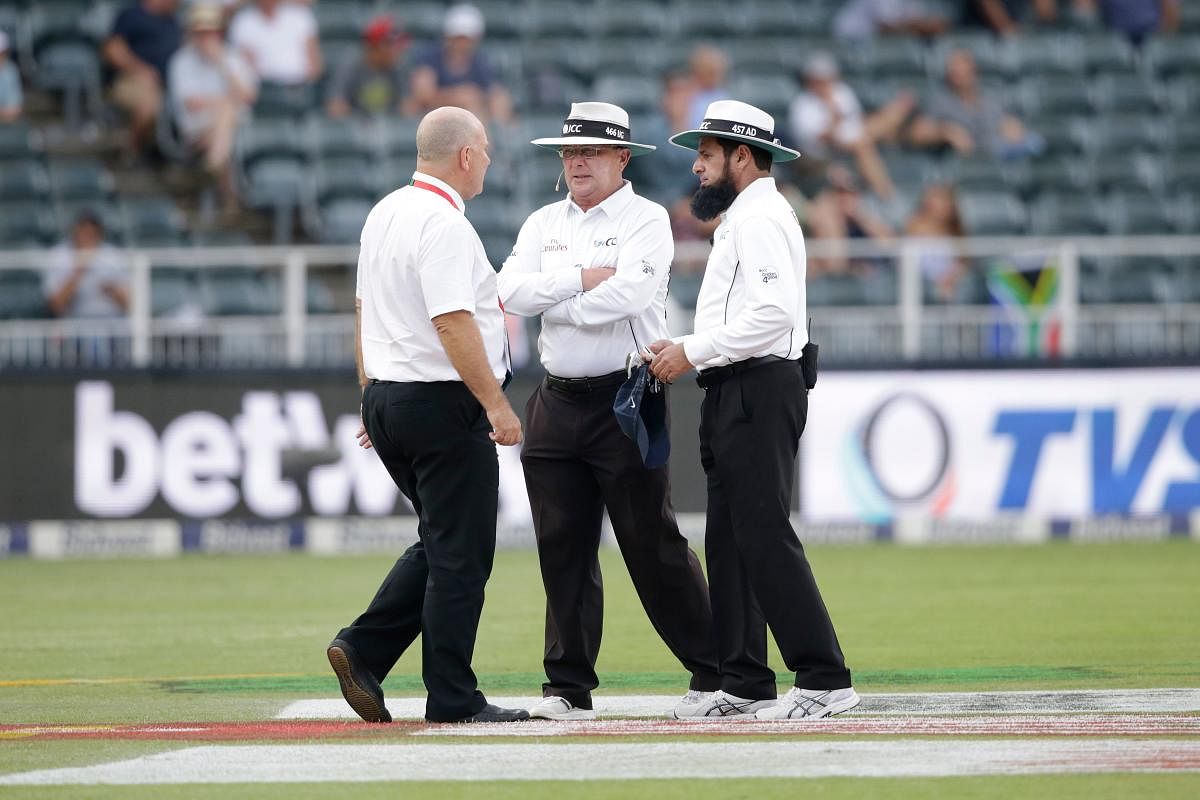 WHAT TO DO? Umpires Ian Gould (centre), Aleem Dar (right) and match referee Andy Pycroft discuss ahead of suspending the day's play during the third Test between South Africa and India at Wanderers cricket ground on Friday. AFP
