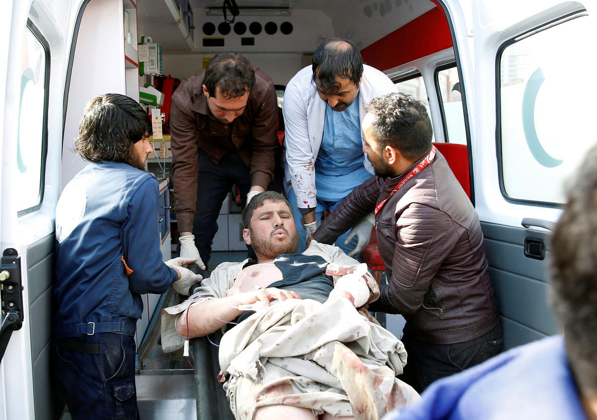 People carry an injured man to a hospital after a blast in Kabul, Afghanistan. Reuters photo