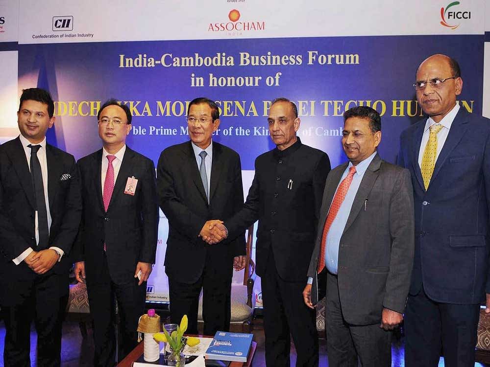 Prime Minister of Cambodia, Samdech Akka Moha Sena Padei Techo Hun Sen and Minister of State for Human Resource Development and Water Resources, River Development and Ganga Rejuvenation, Satya Pal Singh at the India- Cambodia Business Forum, in New Delhi on Saturday. PTI Photo