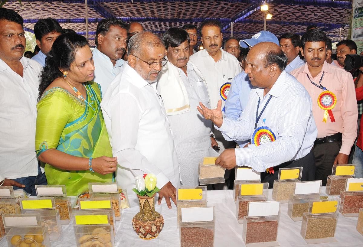 MLA G T Devegowda, PWD Minister H C Mahadevappa and MP R Dhruvanarayan take look on the exhibition, organised as part of valedictory ceremony of centenary celebration of Agriculture Research Center at Naganahalli, in Mysuru taluk, on Saturday.