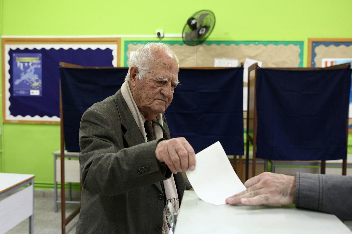A man casts his ballot at a polling station during a presidential election in Limassol, Cyprus, on Sunday. REUTERS