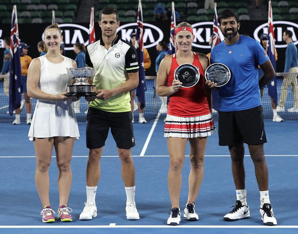 Canada's Gabriela Dabrowski, left, and Croatia's Mate Pavic, second from left, hold their trophy after defeating Hungary's Timea Babos and India's Rohan Bopanna, right, in the mixed doubles final at the Australian Open tennis championships in Melbourne. AP/PTI photo.