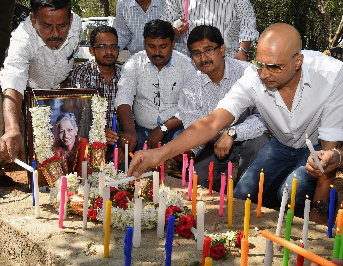Indrajit Lankesh lights a candle at a memorial organised on his sister Gauri Lankesh's birthday in Bengaluru on Monday. DH Photo.