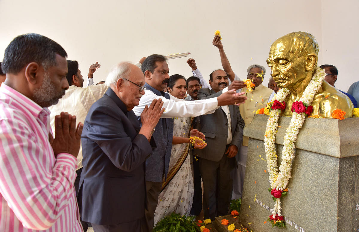 University of Mysore in-charge Vice Chancellor C Basavaraju pays floral tributes to Mahatma Gandhi's bust to mark the 70th Sarvodaya Day on Gandhi Bhavan premises at Manasagangothri in Mysuru on Monday. Gandhi Bhavan Director M S Shekar, historian B Sheik Ali, and Registrar D Bharathi are seen. DH PHOTO