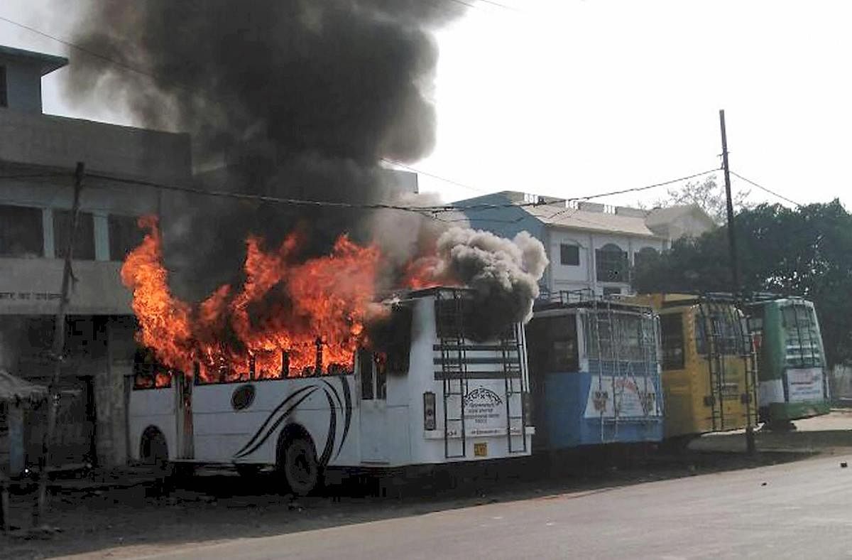 A bus set on fire by a group of people who went on a rampage in Kasganj. PTI