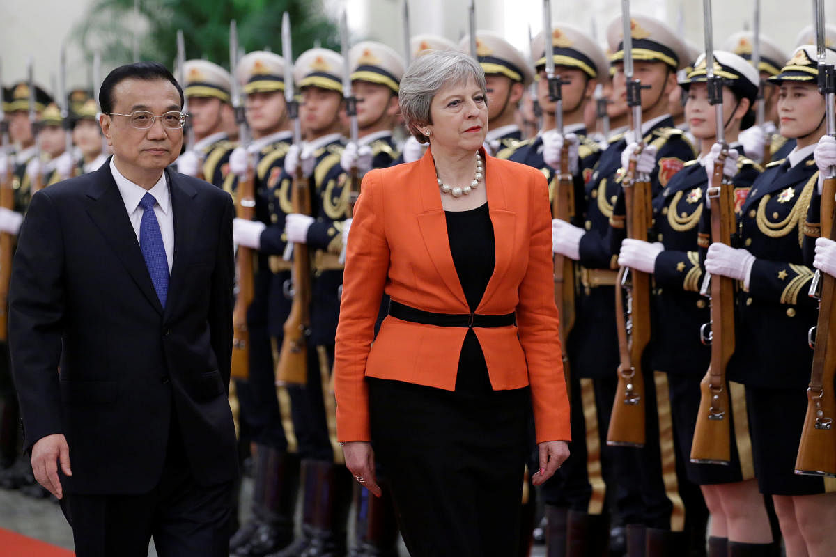 British Prime Minister Theresa May and Chinese Premier Li Keqiang review honour guards during a welcoming ceremony at the Great Hall of the People in Beijing, China, on Wednesday. REUTERS