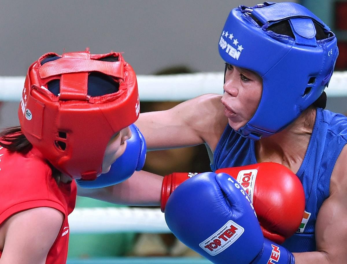 THWACK! India's M C Mary Kom (right) lands a blow on Mongolia's Altantsetseg Batsaikhan in the women's light flyweight semifinal bout on Wednesday. PTI